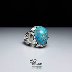 High-grade Neyshabur turquoise with natural golden-brown veining, set in a handmade sterling silver ring
