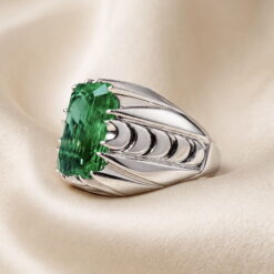 Green lab-created emerald silver ring seen from an angle, showing the depth of the step-cut facets